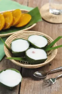 3 kleine thailändische Desserts aus Kokosnuss in Palmenblättern dekoriert